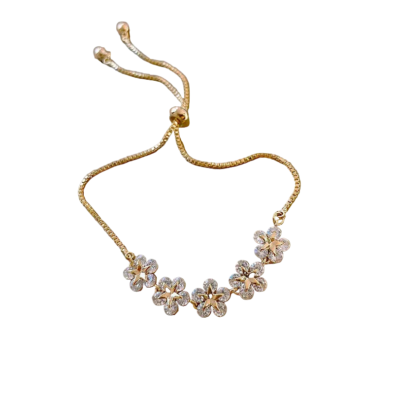 Gold necklace with floral designs on a beige box